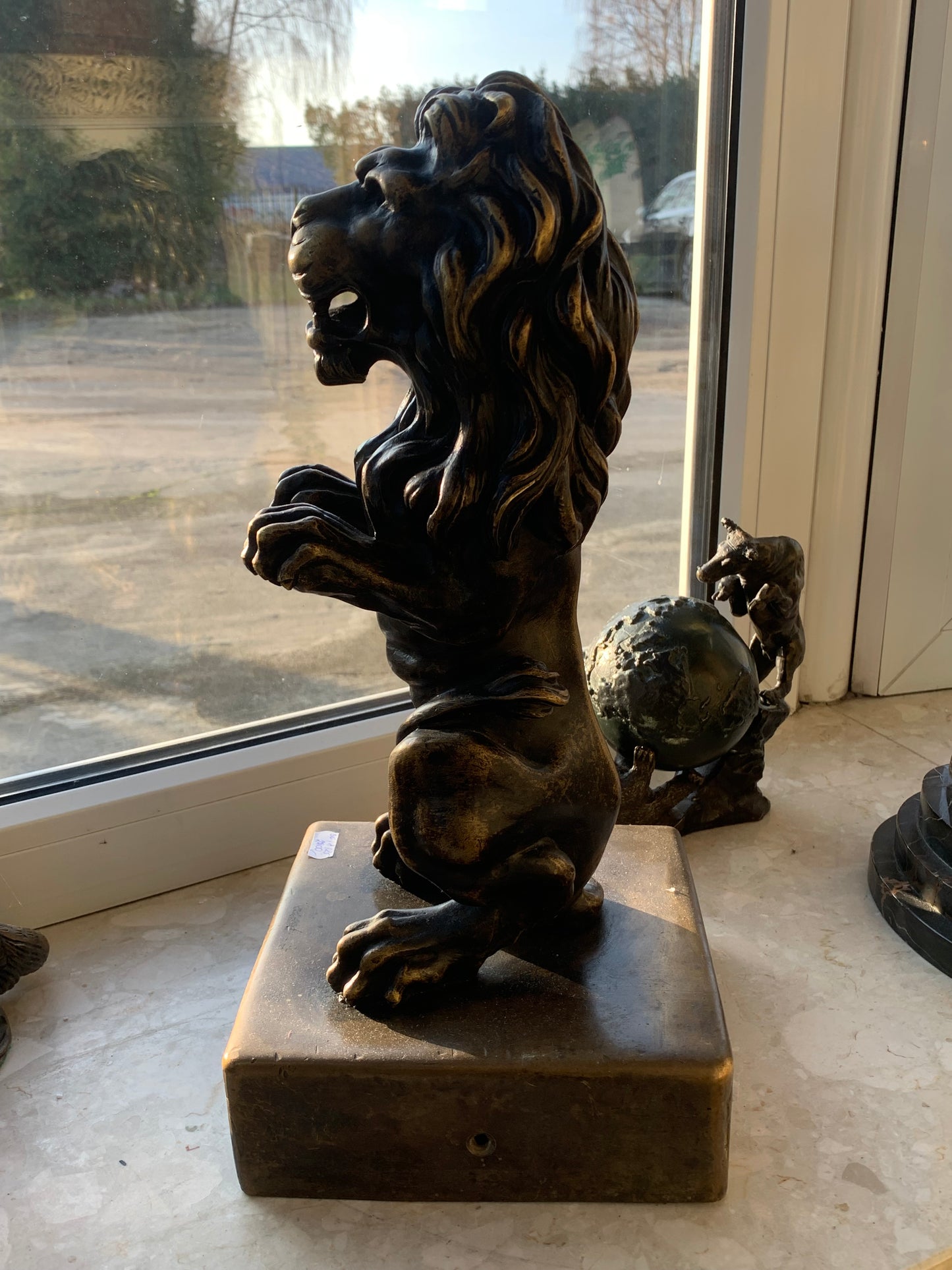 Bronze sculpture of a lion on a base