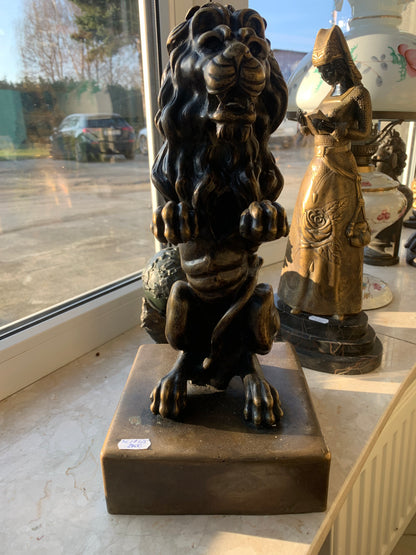 Bronze sculpture of a lion on a base