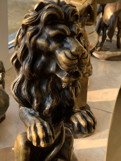 Bronze sculpture of a lion on a base