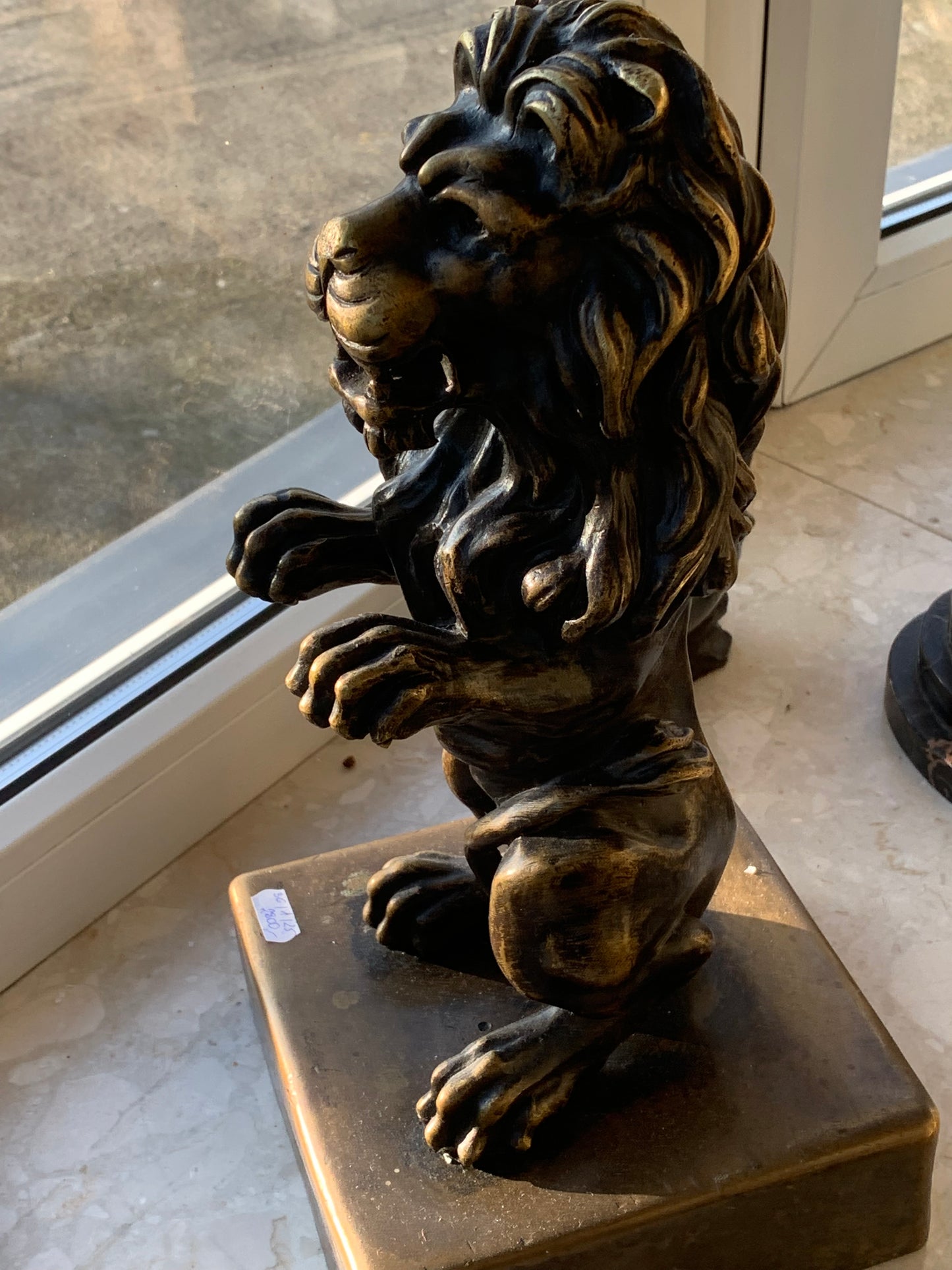 Bronze sculpture of a lion on a base