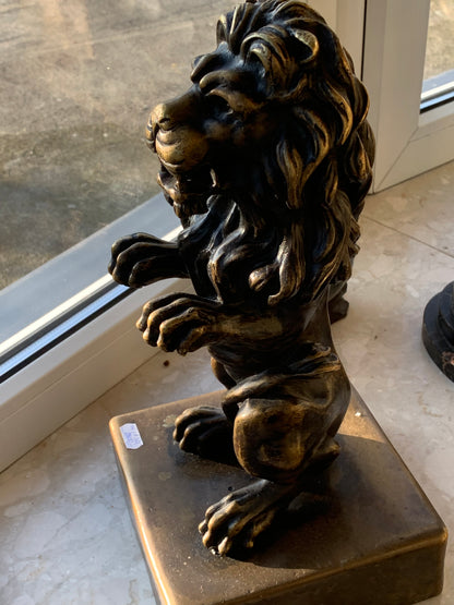 Bronze sculpture of a lion on a base
