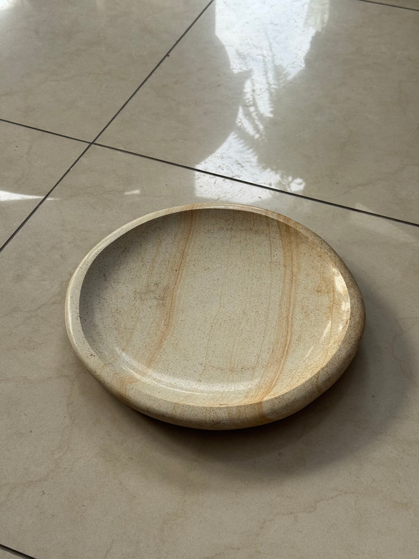 A decorative plate made of sandstone