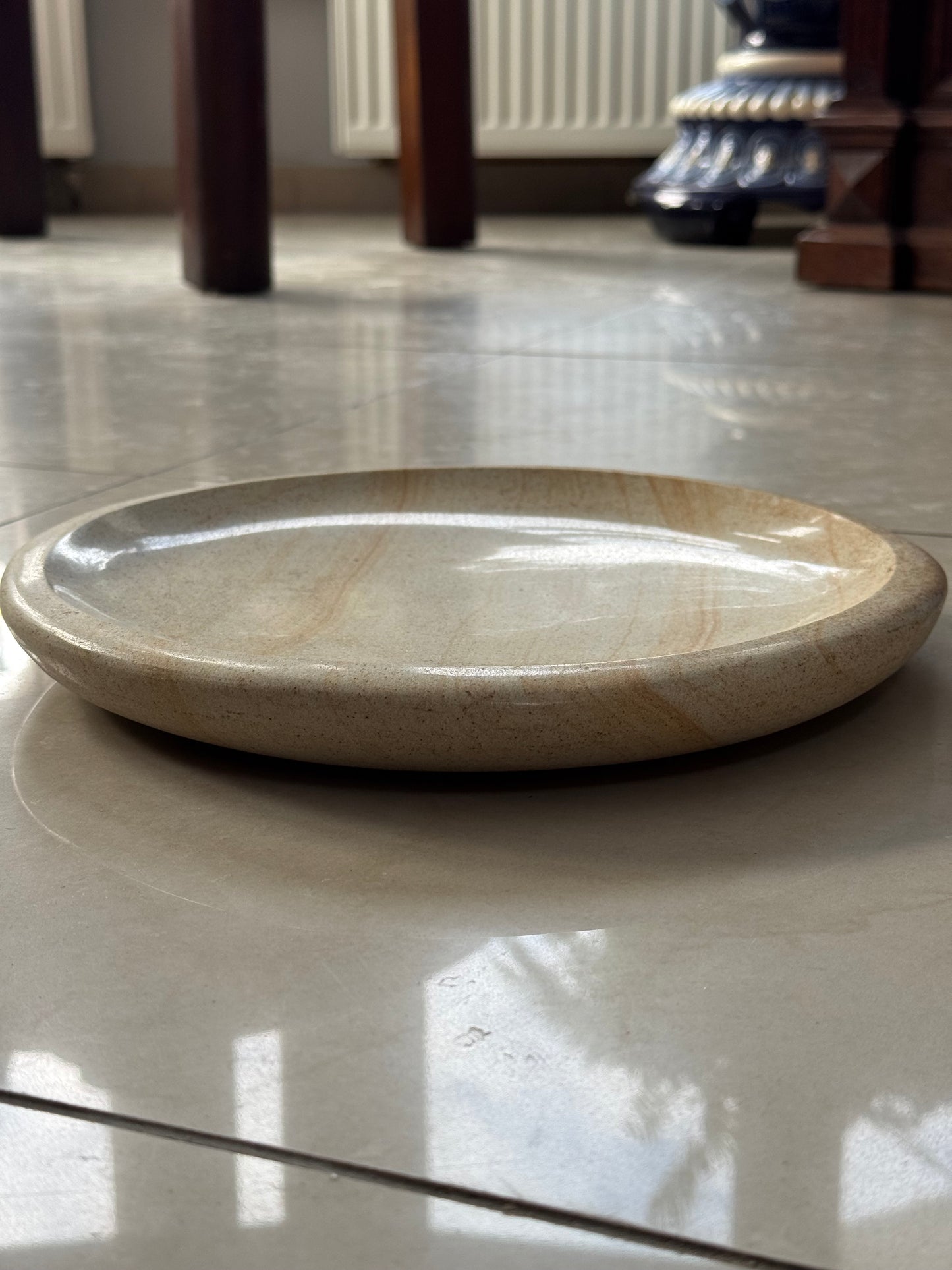 A decorative plate made of sandstone