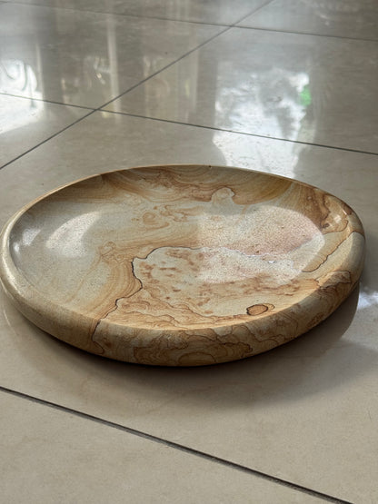 A decorative plate made of sandstone
